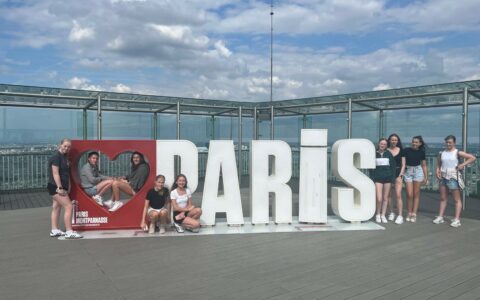 students outside next to Paris sign