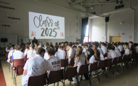 Students sat in a hall enjoying their year 11 leavers presentation